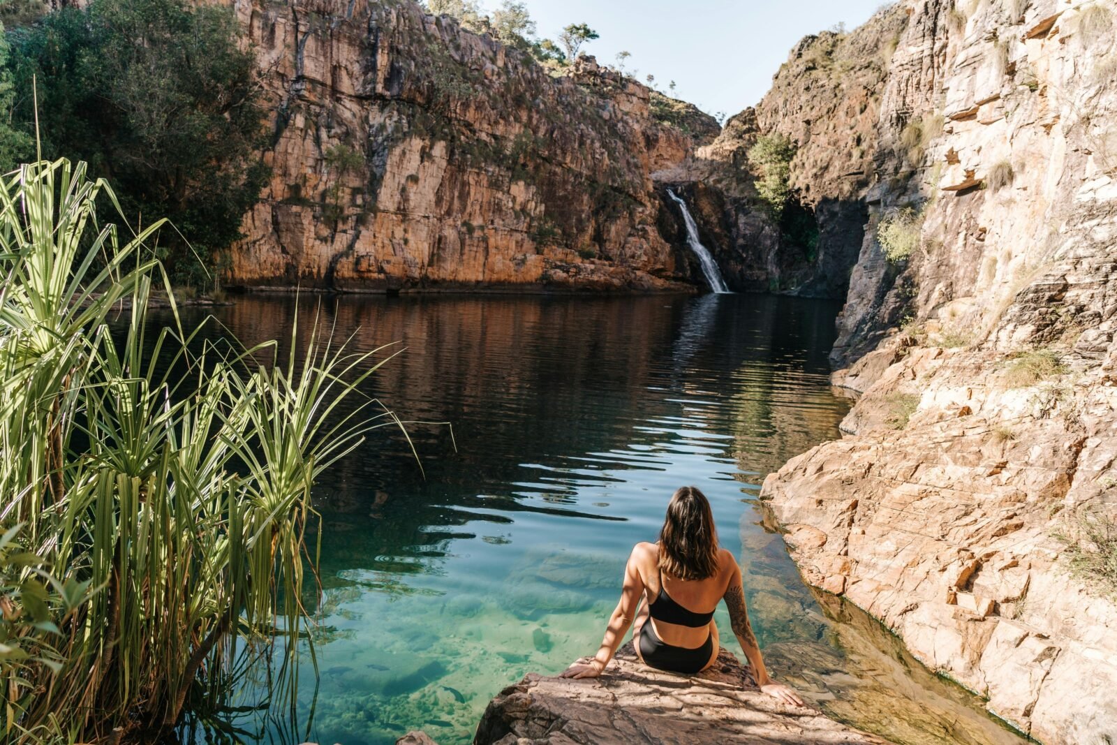 Woman looking at Maguk waterfall