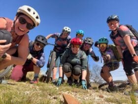 women supported group crouching mountain bike Alice Springs retreat