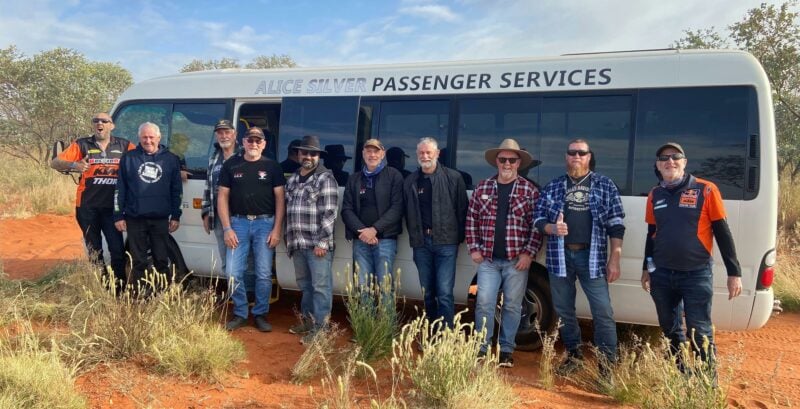 men standing by a bus
