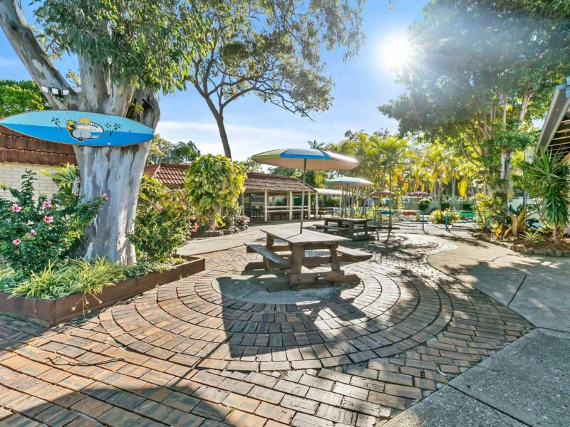 Paved, outdoor courtyard with picnic tables