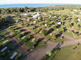 Well grassed and treed drive thru sites with ocean in background