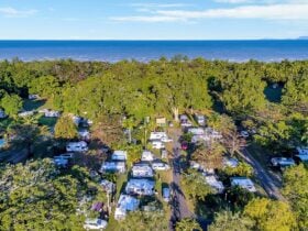 Image showing a full Resort with Caravans, Camping and Motorhomes from above. Beach in the distance