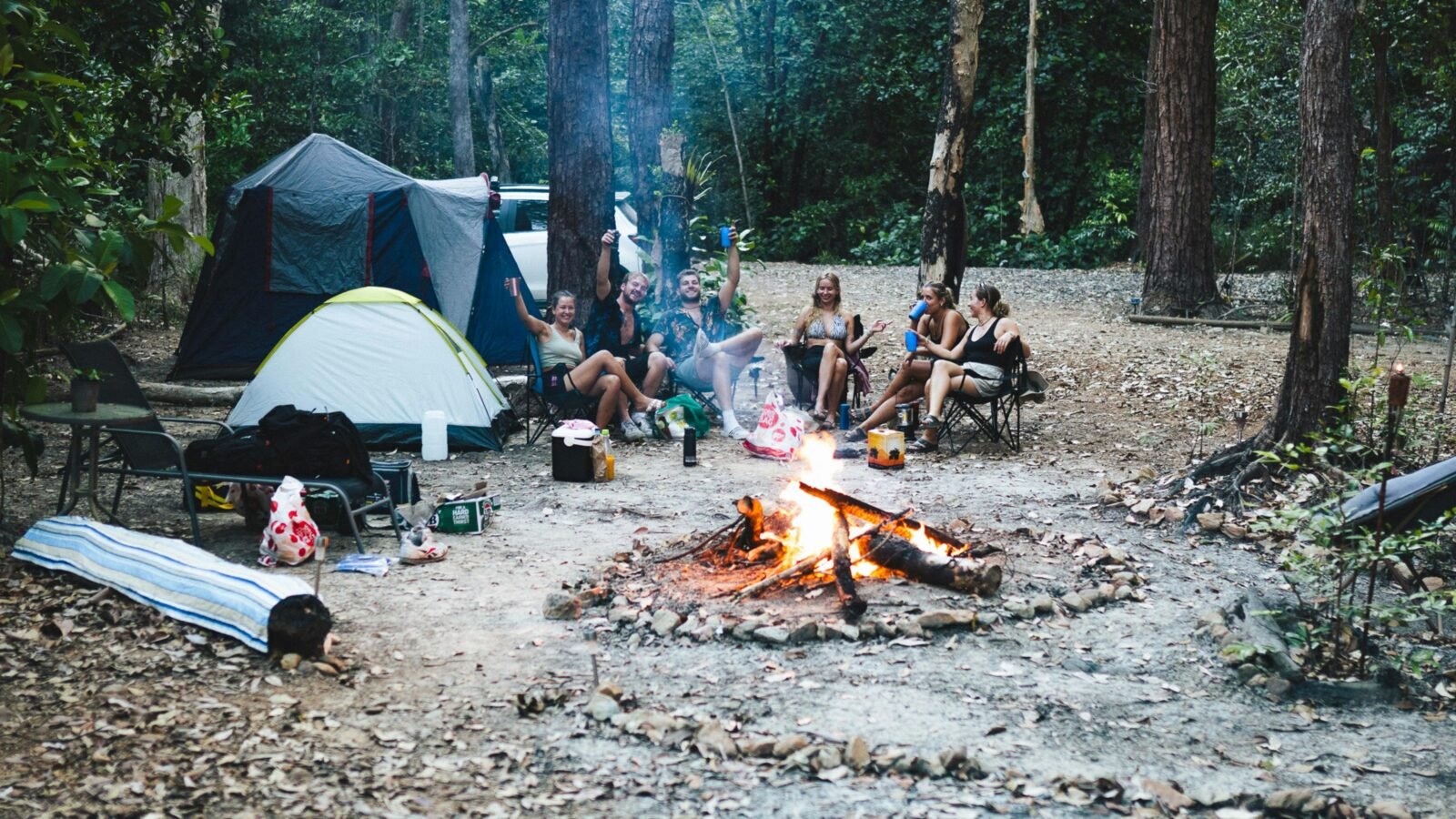 Campers having a jolly time around the fire