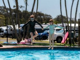 Shot of kids jumping into a pool at Dicky Beach Holiday Park
