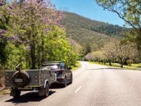 Car and campervan driving along a country road
