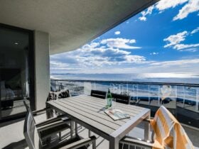 ocean front apartments with beach views and table for outdoor meals