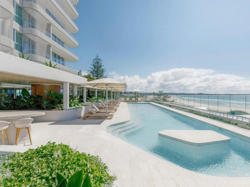 Pool Deck at Kirra Point with ocean views, sun loungers and umbrellas.