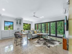 Lounge room showing the lounge, table and chairs, plus the bi-fold doors and day bed.
