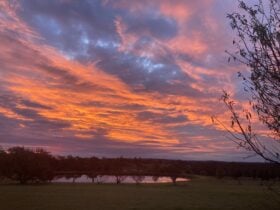 Spectacular orange sunset over dam