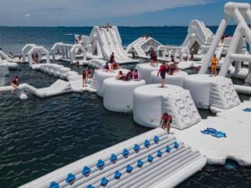 Image of inflatable water park with people playing on it