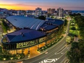 Aerial view of the Cairns Convention Centre at dusk, showcasing its modern architecture with a large