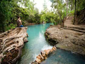 Young woman admiring the view at the Cardwell Spa Pool