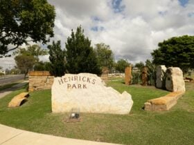 A large sandstone sign inscribed with 