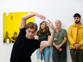 Person with arms outstretched above their head dancing