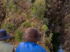 Aerial view of people looking down at kinbombi falls from the lookout