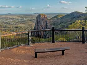 High view of surrounding landscape with bushland and buildings.