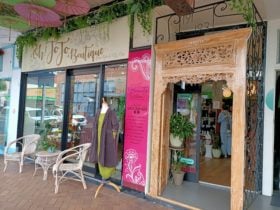 Street shot of the front of the store showing display window and beautiful timber doors.