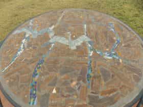 Hand crafted tables made from rims of wagon wheels and created by local artists