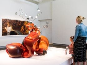 Woman and young girl viewing twisted scooter sculpture