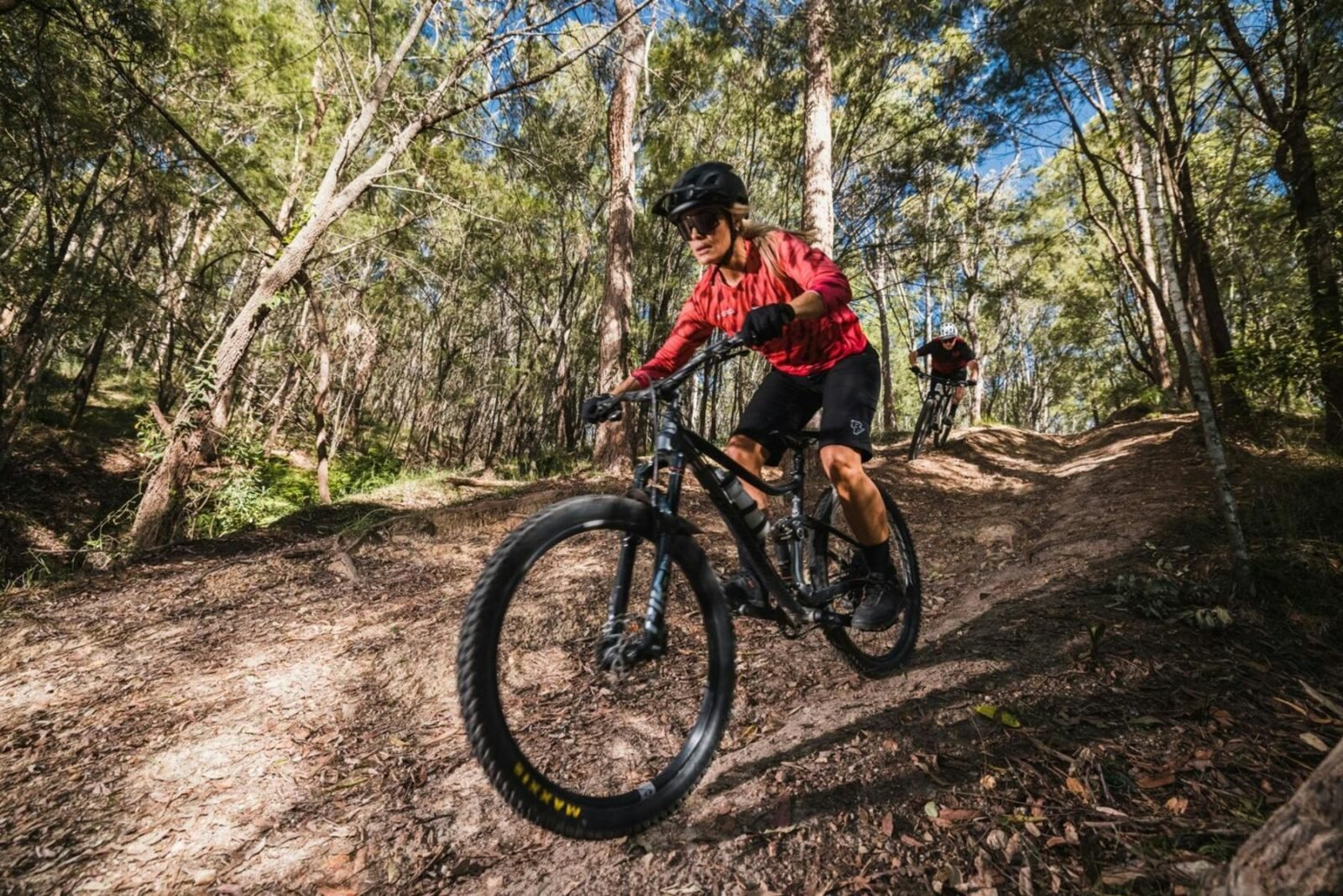 Couple riding mountain bikes and enjoying trails at Redlands Track Park, QLD.