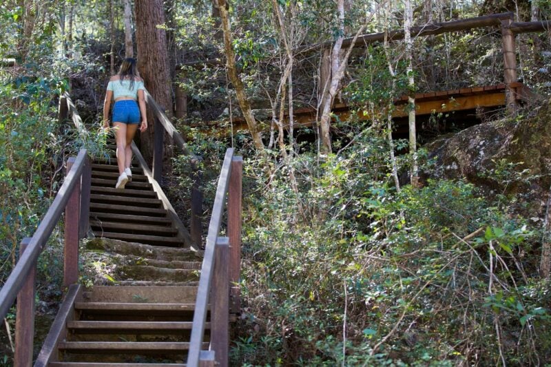 Woman walking up stairs towards Rocky Hole
