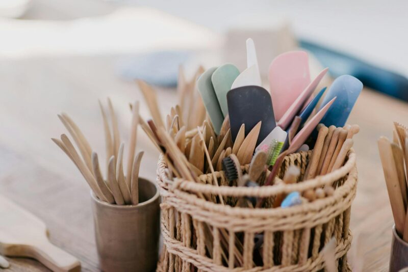 woven container with wooden clay handbuilding tools in it