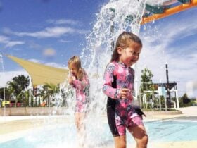 Girls playing at The Mill Water Park Petrie under Water Buckets