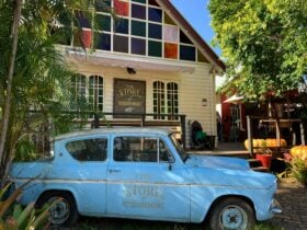 blue car in front of shop