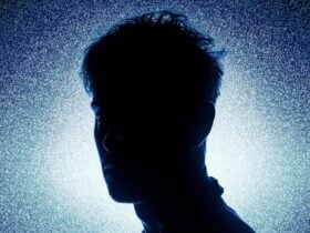 A Silhouette of a man against a dark blue background.