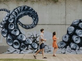 Large outdoor mural with people viewing