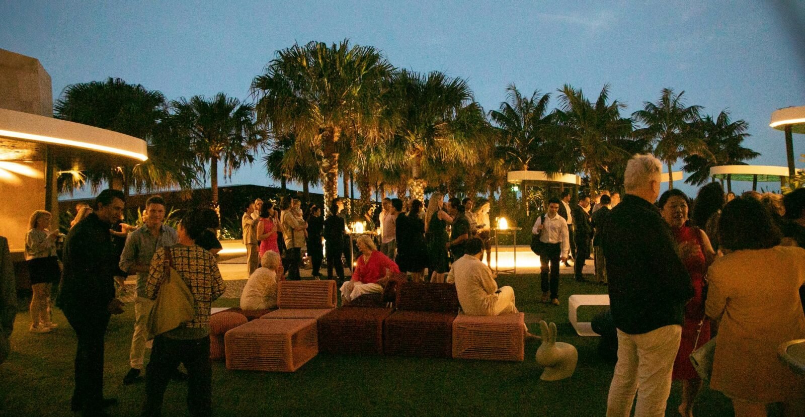 A group of people celebrating at dusk the Opening Night of the APSA Forum