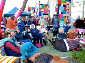 A market scene with people sitting on sofas outside