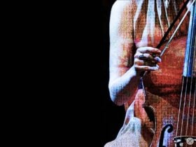 Female musician playing an ornate baroque cello