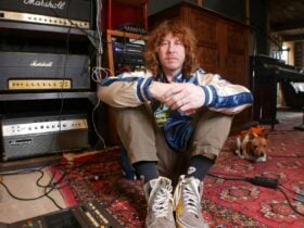 Ben Kweller sitting on the floor in front of music equipment