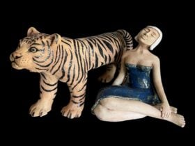 Clay sculpture of a tiger and a seated woman