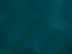 A cloud of blue and green with pinpricks of stars shining through