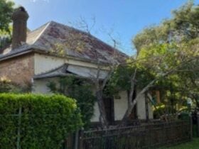An old house with a tin roof and large chimney