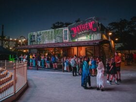 People in a queue outside the Mayhem Maze attraction.