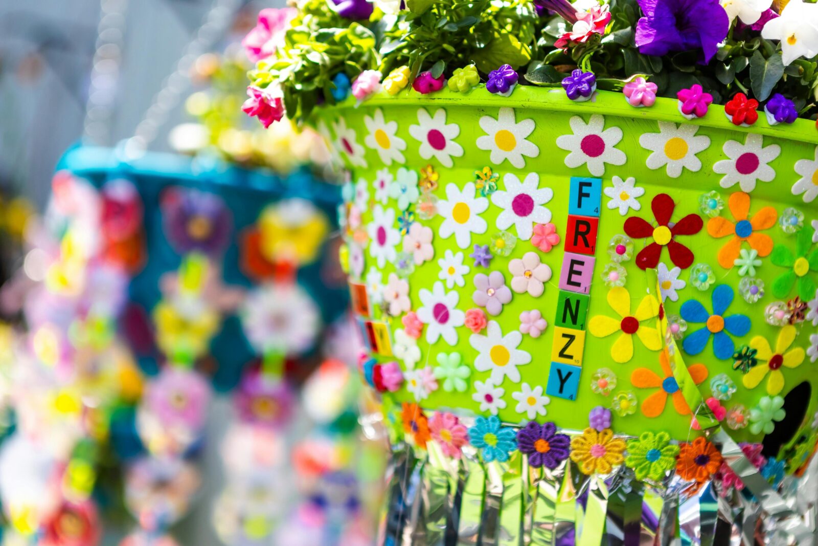 Green hanging flower basket with flower stickers and "FRENZY" spelled out on pot.