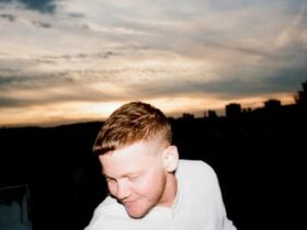 Kae Tempest in front of a sunset