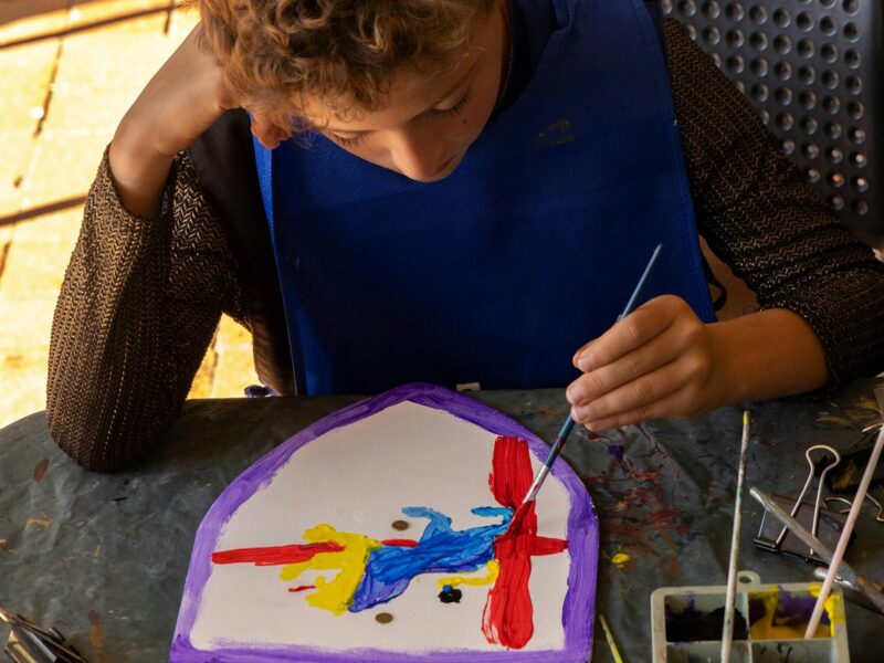 boy painting shield