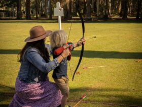 mother and son practicing archery on lawns