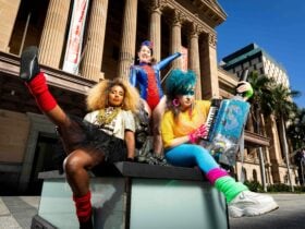Three dancers dressed colourfully at King George Sqaure