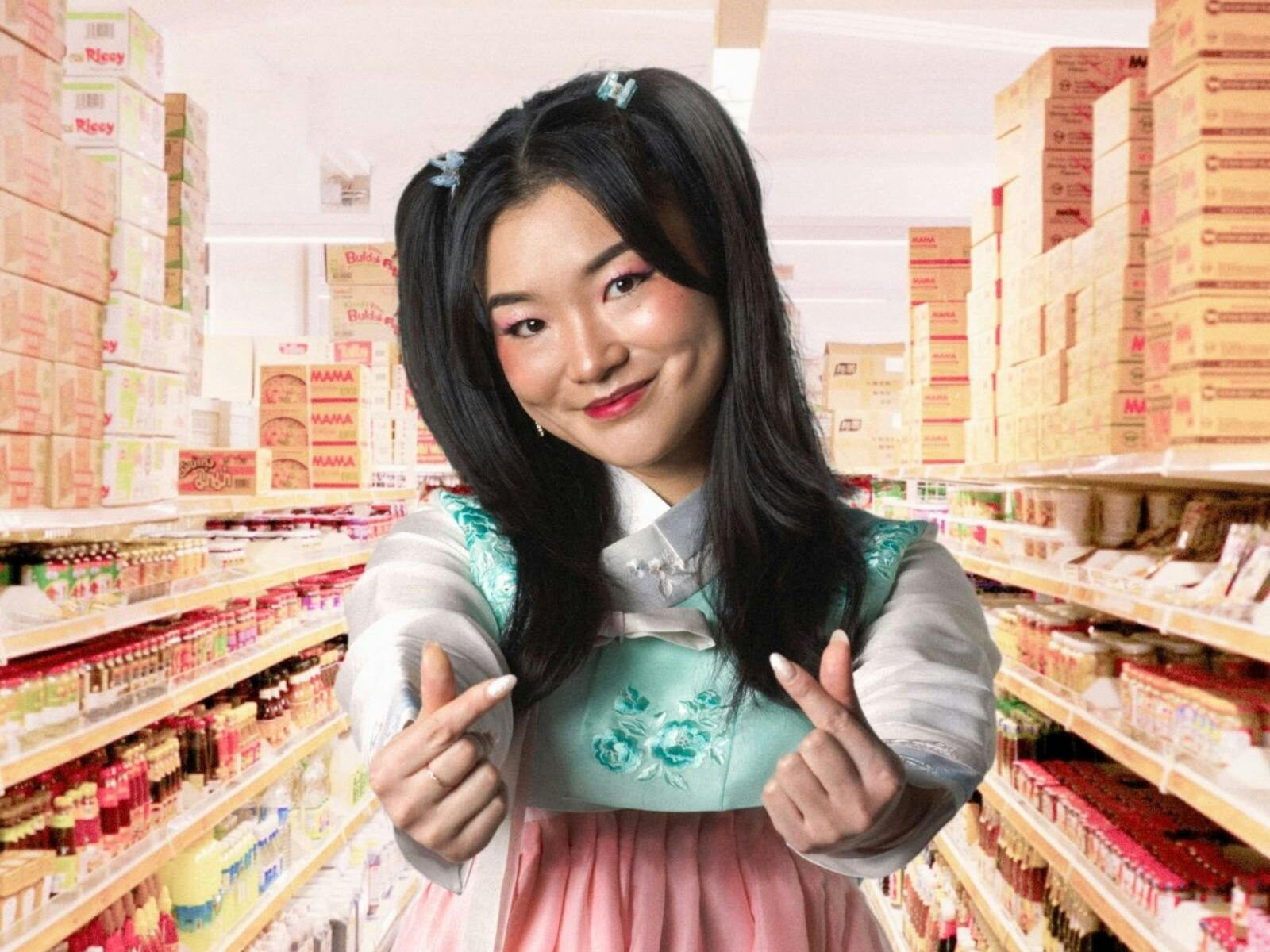 A women posing with a heart hand gesture