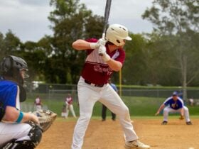 Softball Queensland Player with bat.