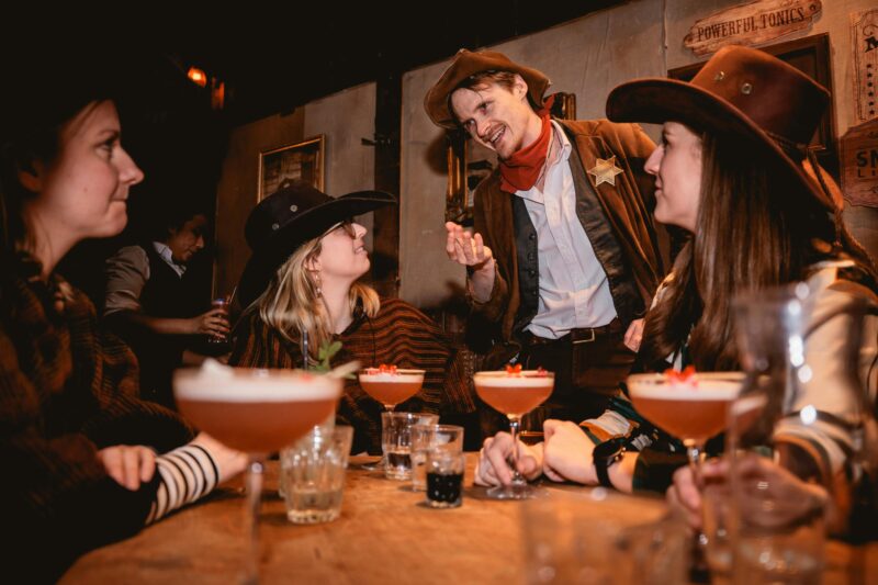 Friends dressed in western-style clothing enjoying drinks together