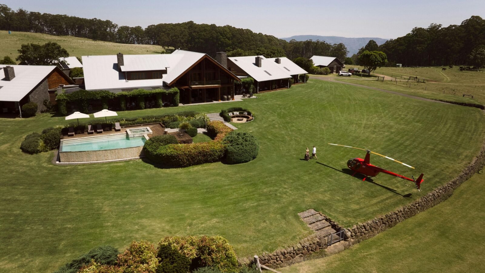 Aerial shot of Spicers Peak Lodge with a helicopter