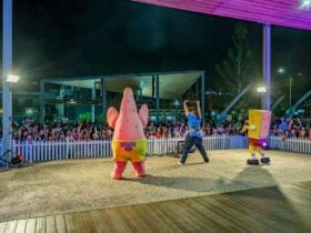 Spongebob, Patrick and performer on stage with the crowd in the background