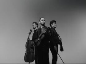 Rory Smith holding Cello, Jason Tong holding Violin and Brendan Joyce holding Violin