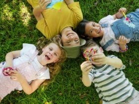 Playtopia at Roma Street Parkland kids relaxing on the grass